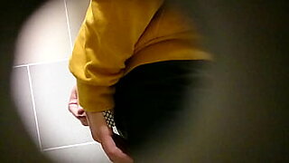 Girls pissing in urinal